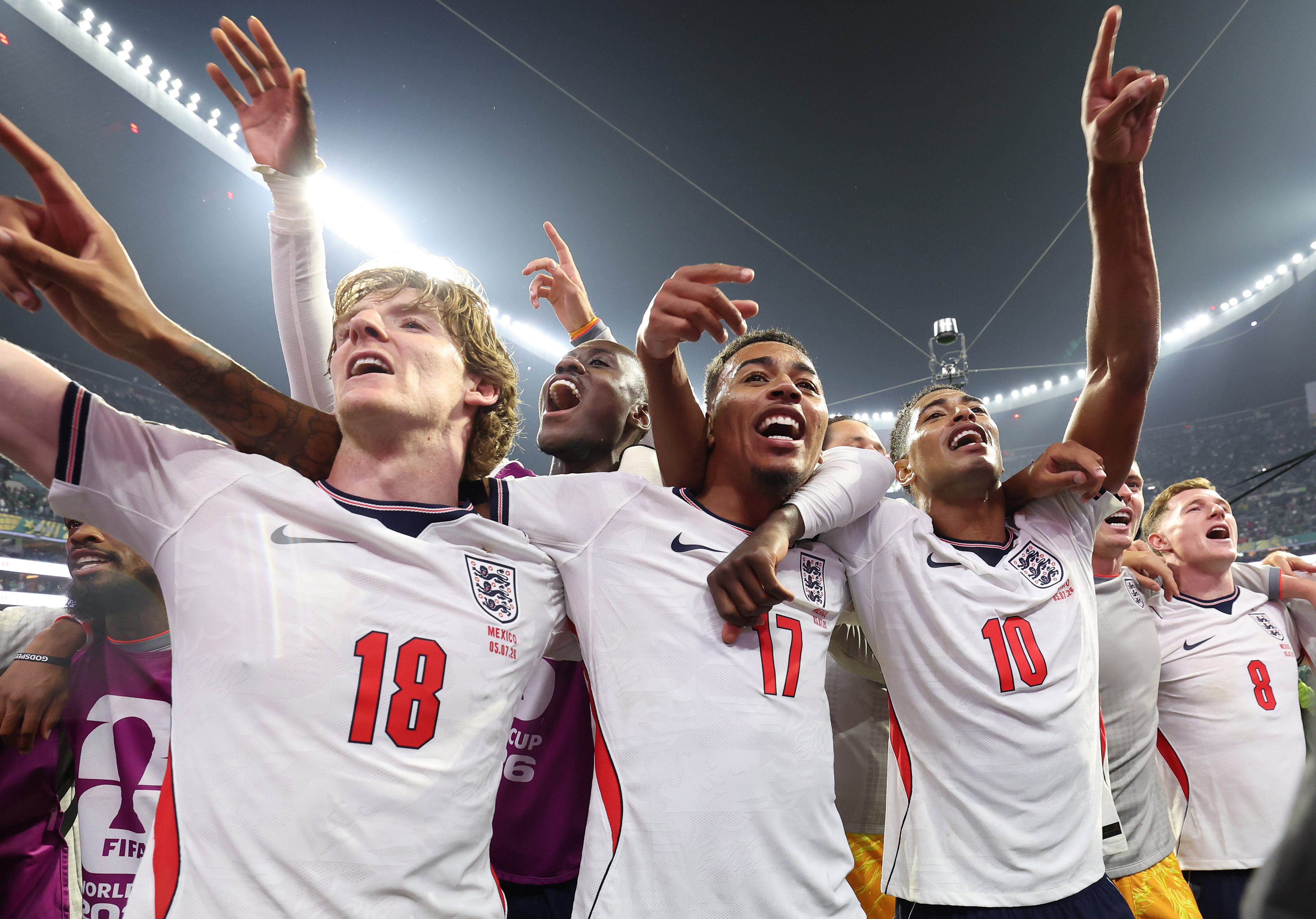 England players, arms round each other, smiling and singing.