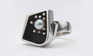 Silver ring with black face and pearl inlaid
