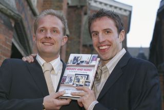 Andy Woodman and Gareth Southgate pose with a copy of the book they wrote together in 2004.