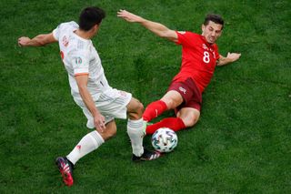 Remo Freuler tackles Spain's Gerard Moreno in a challenge which earns the Switzerland midfielder a red card at Euro 2020.