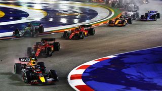 Sergio Perez of Mexico driving the (11) Oracle Red Bull Racing RB18 leads Charles Leclerc of Monaco driving the (16) Ferrari F1-75 and the rest of the field at the start during the F1 Grand Prix of Singapore at Marina Bay Street Circuit