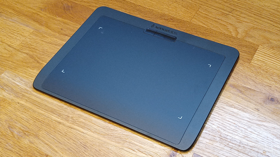 Xencelabs Pen Tablet Small review; a dark grey drawing tablet on a wooden table