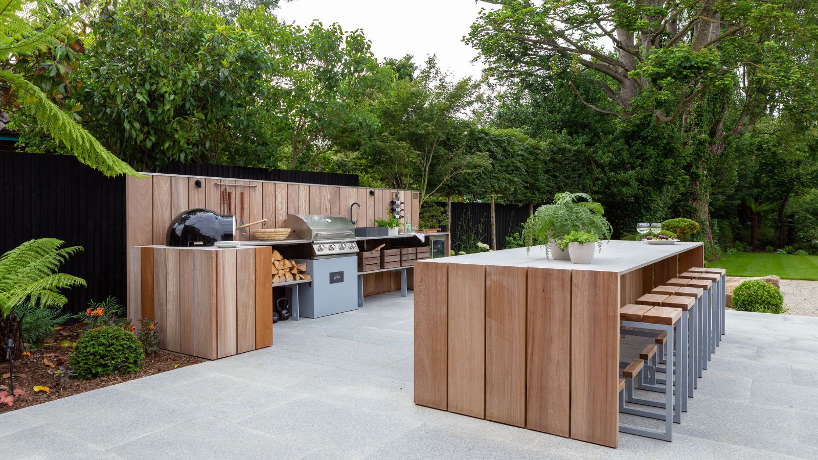 An outdoor kitchen made from wood with a large island