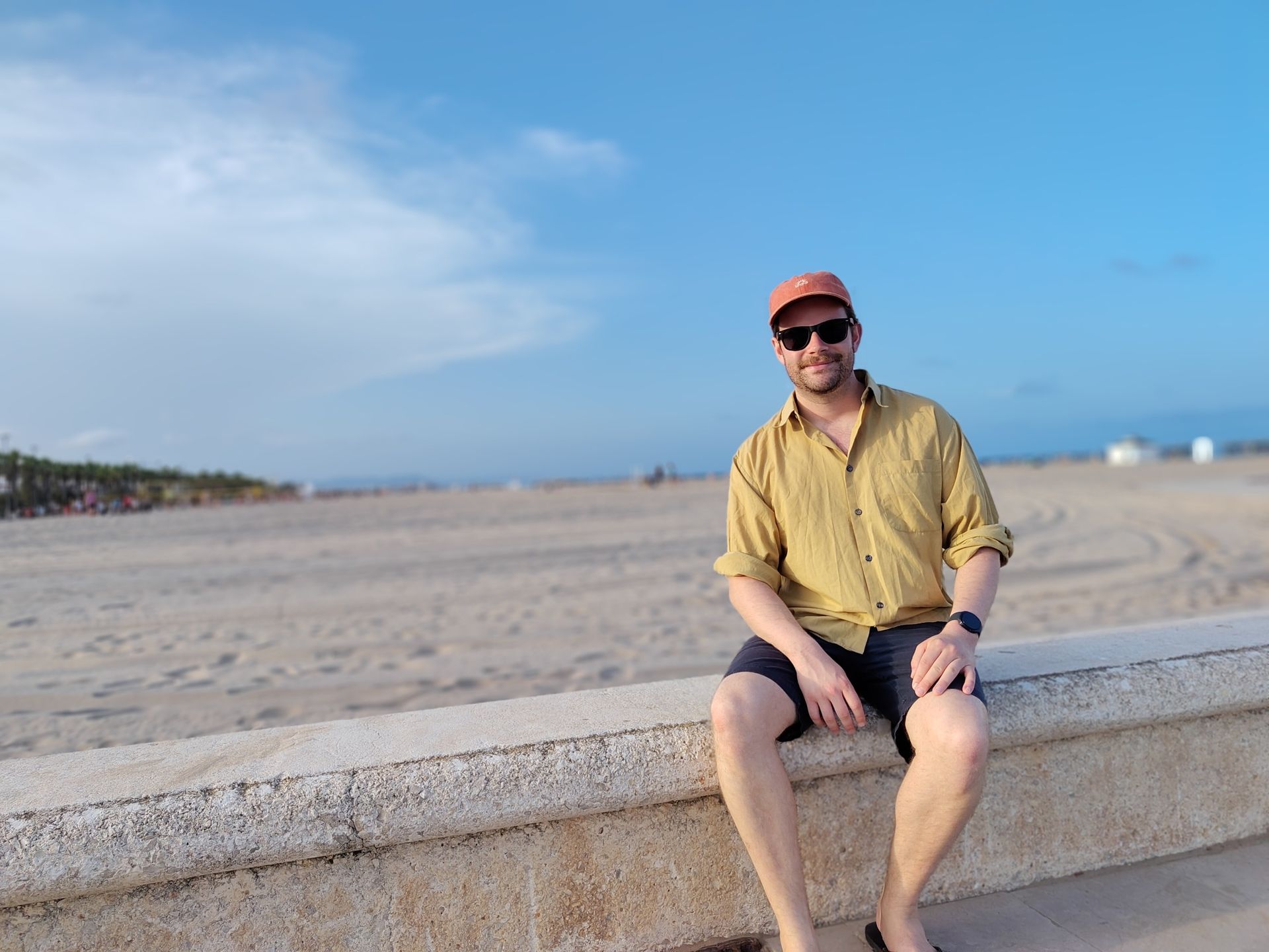 A picture of a man by a beach, taken on the Fairphone 6 Plus.