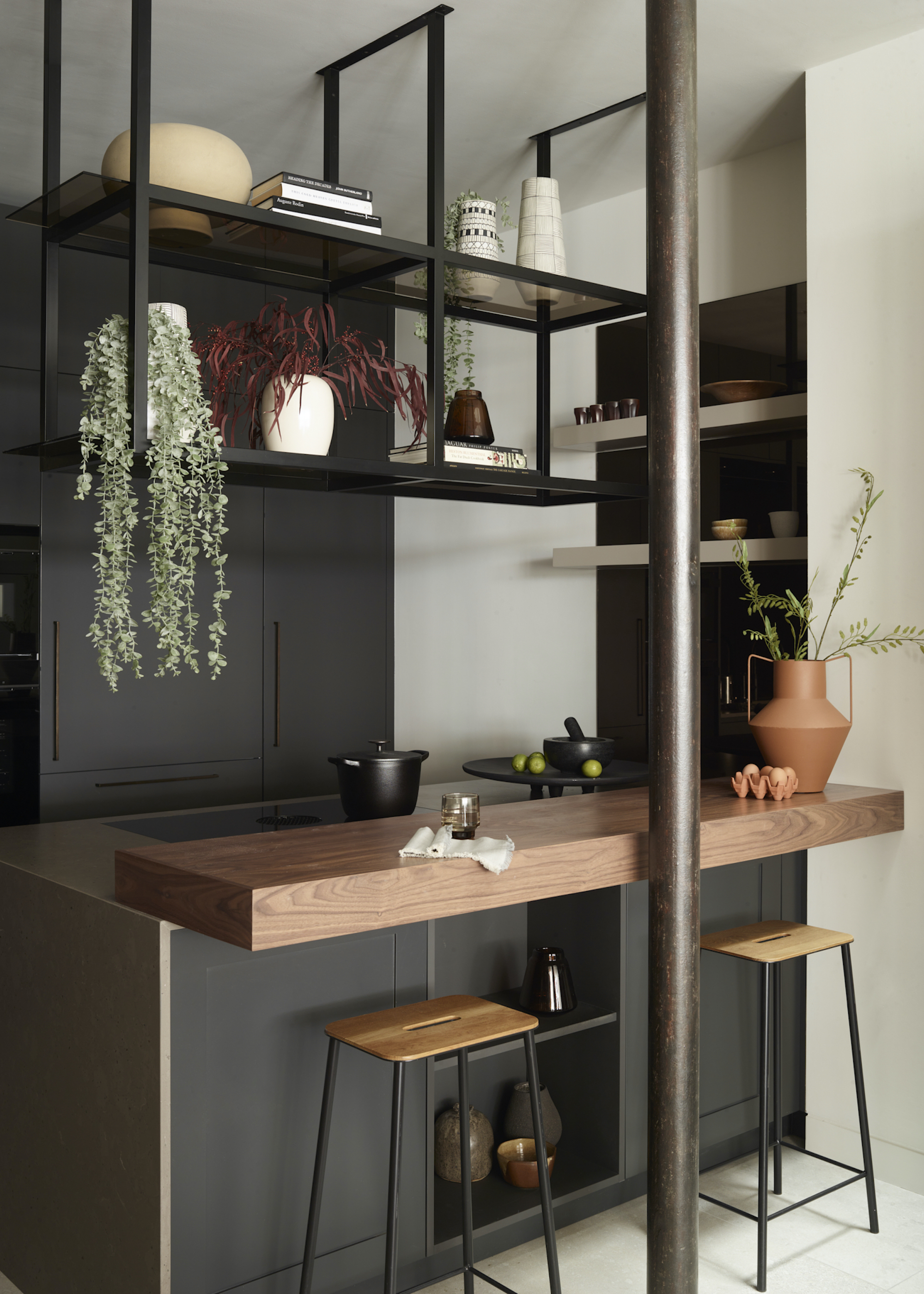 small kitchen with black cabinets and suspended storage