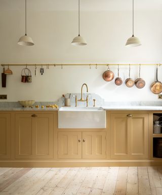 deVOL Kitchens beige kitchen with hanging lights, wooden flooring and wooden cabinets, with white worktops