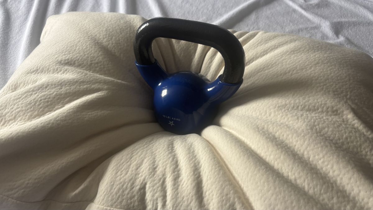 A 10lbs weight is place on the middle of the Birch Organic Pillow to test its responsiveness.