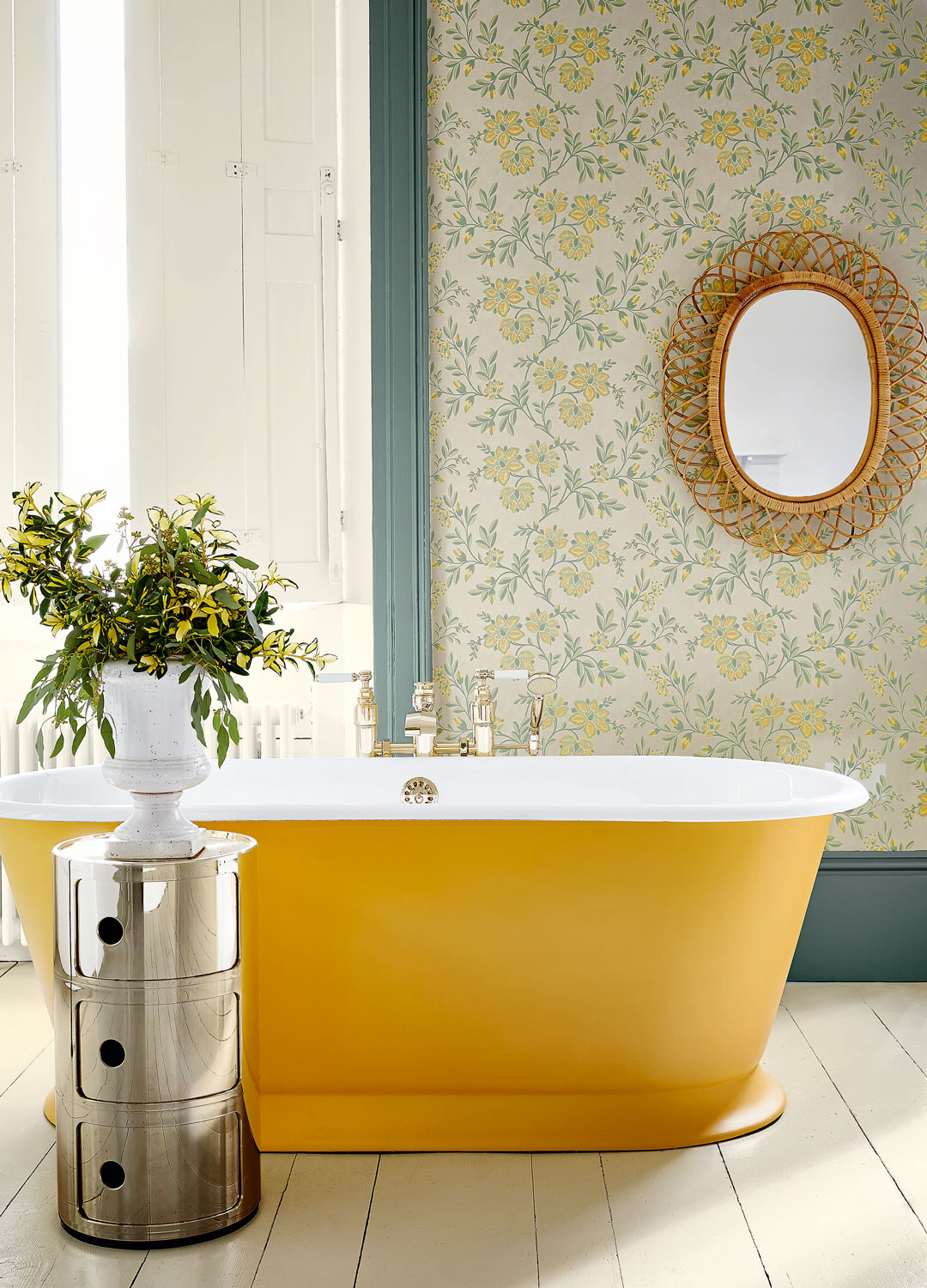 blue and yellow bathroom with yellow freestanding bath and floral wallpaper