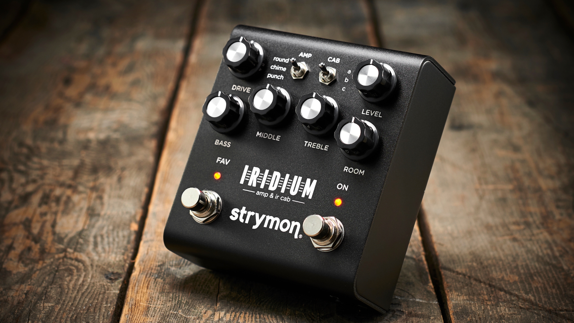 A Strymon Iridium pedal amp on a wooden floor