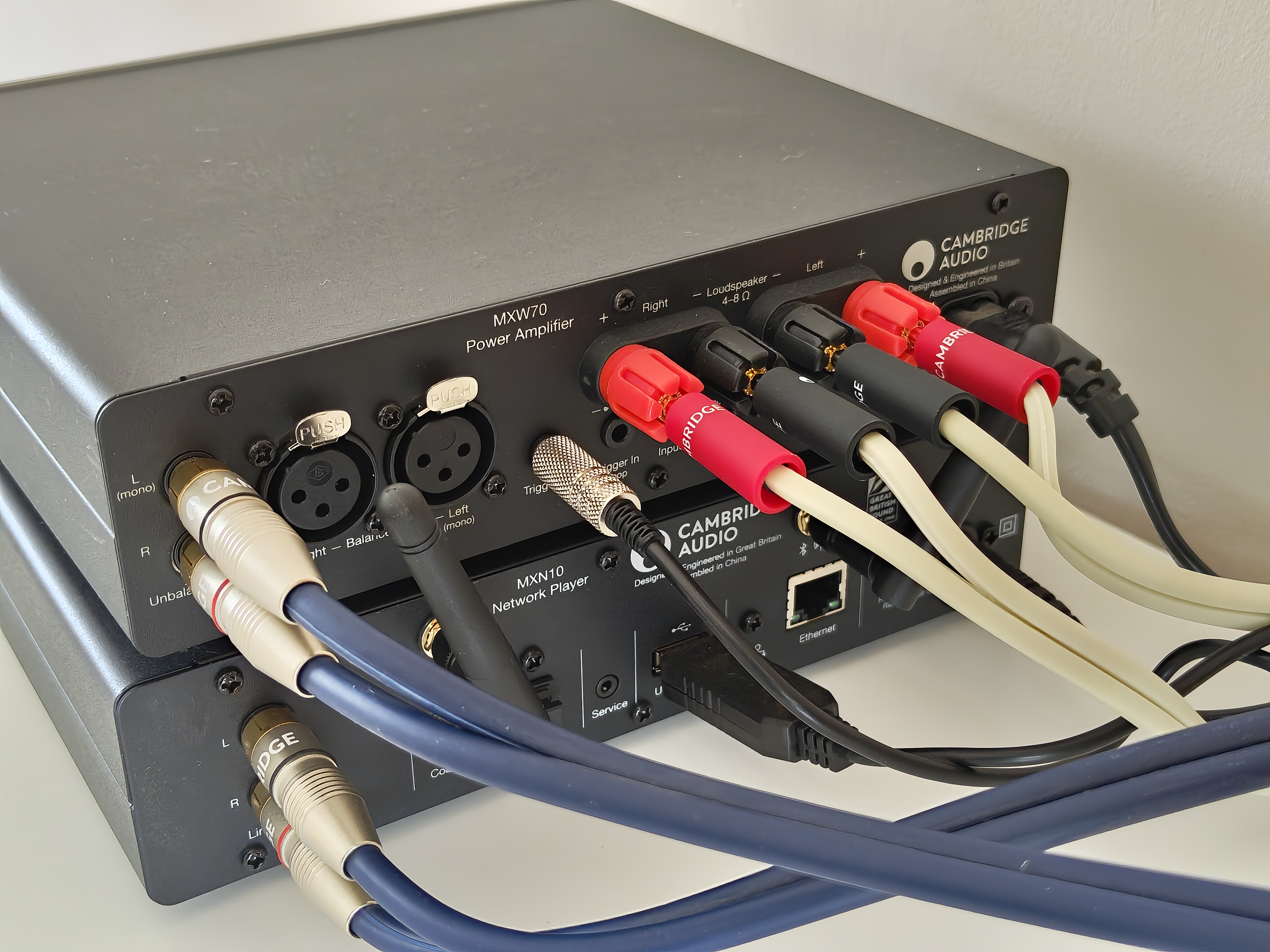 Cambridge Audio MXW70 power amp on book shelf with streamer