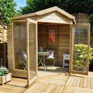 wooden summerhouse with plant pots