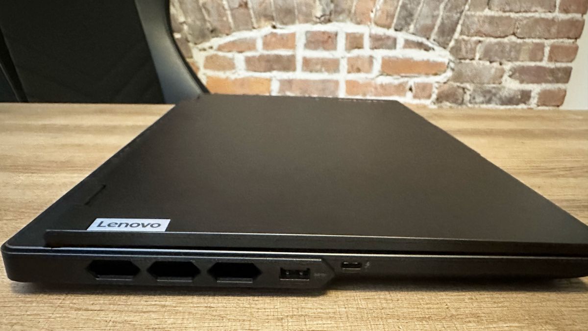 Lenovo Legion Pro 7i (Gen 9) closed on a wood table, highlight ports on the left, including USB Type-A and Thunderbolt 4.