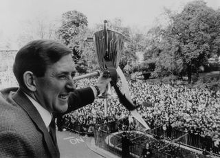 Tottenham Hotspur and Northern Ireland footballer, Danny Blanchflower, holding the European Cup Winners Cup outside Tottenham Town Hall during a civic reception.