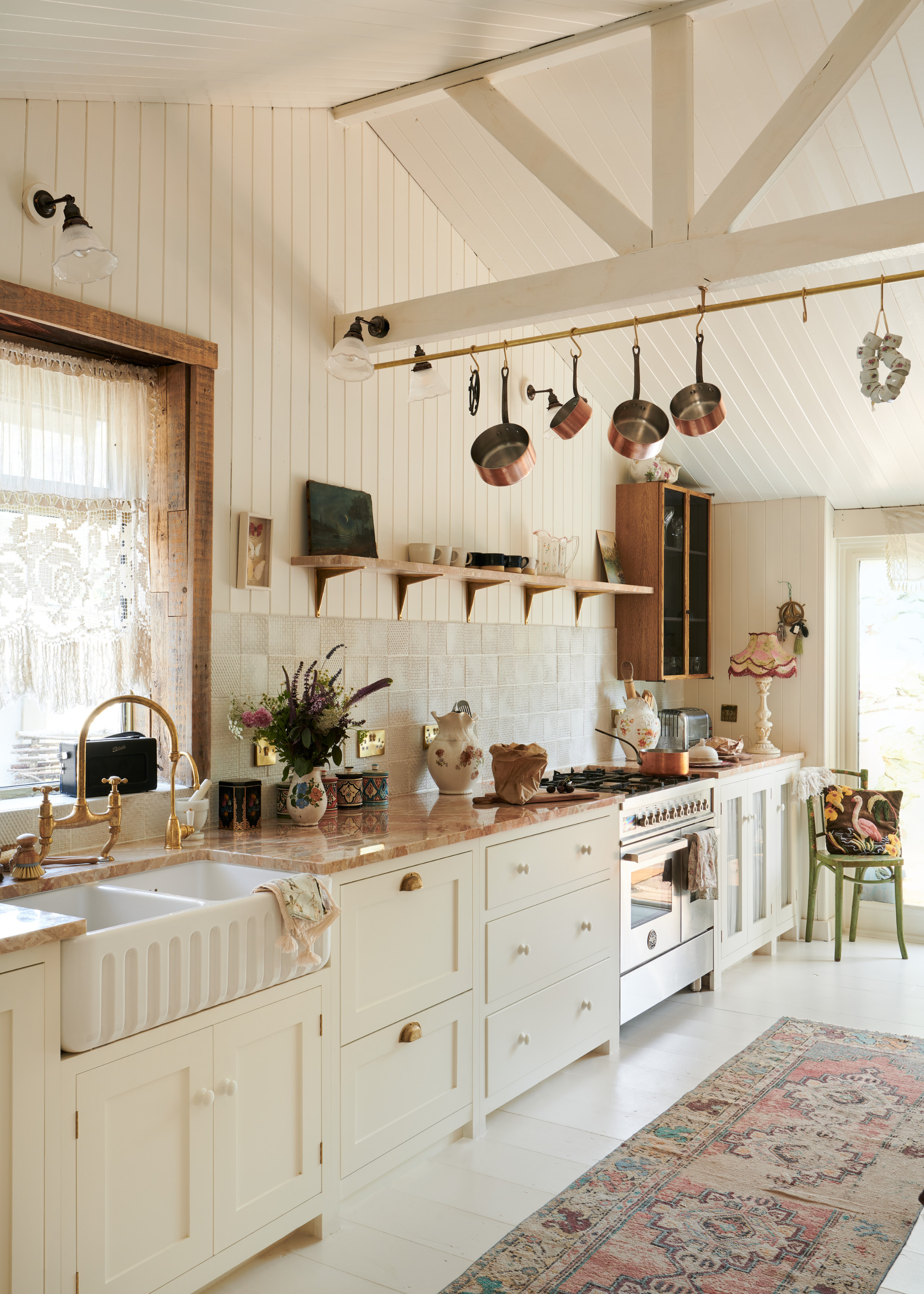 gorgeous vintage-look kitchen in a cottage home, all white but warm and welcoming