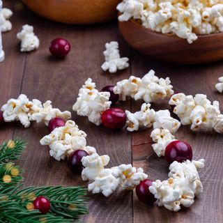 Making a popcorn garland with cranberries