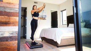 person using the Vitruvian V-Form Trainer in their bedroom