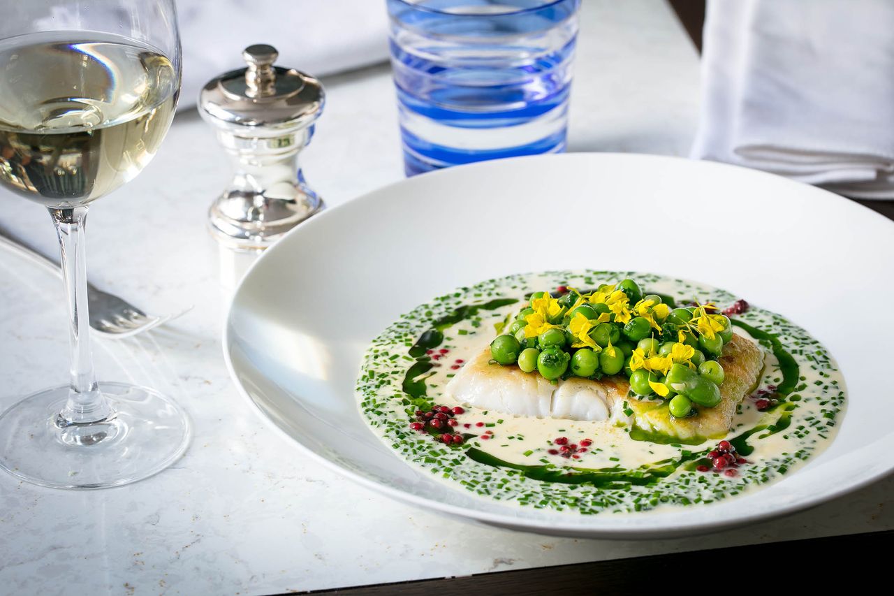 Hake with peas and green beans in a white wine and pink peppercorn sauce.