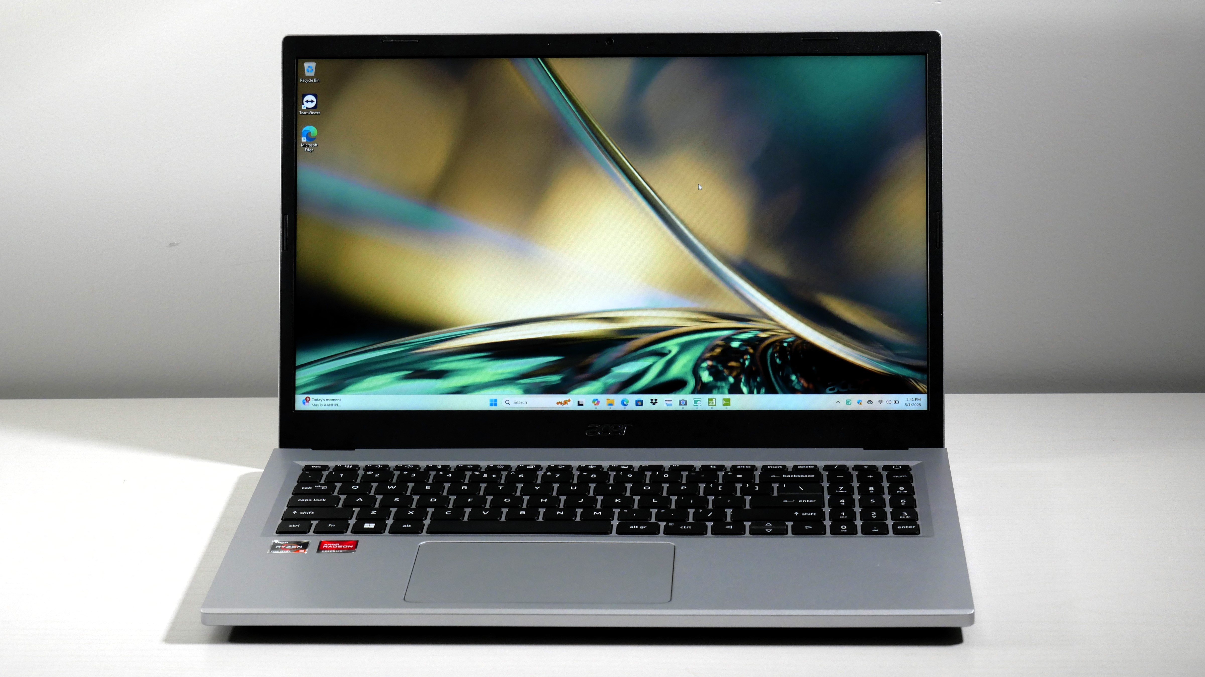 Acer Aspire 3 15 open on a white desk, highlighting the dull display.