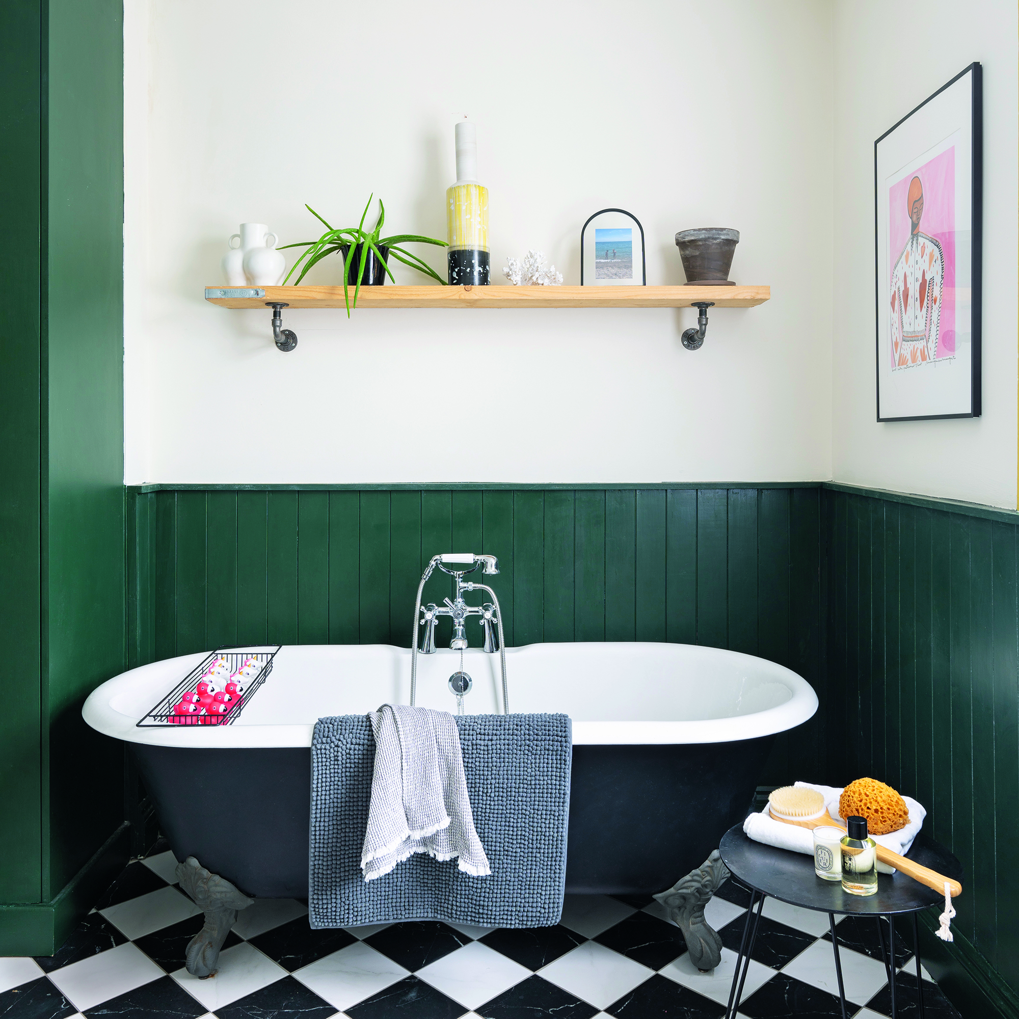 Bathroom with black bath, green panelling and open shelving