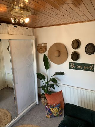 Hats stored on a wall next to mirrored wardrobe