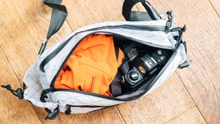 the inside of a hip bag with a camera and jacket inside