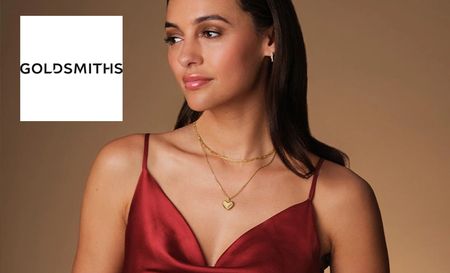 Model wearing a red dress modelling Goldsmith's heart gold necklace and earings