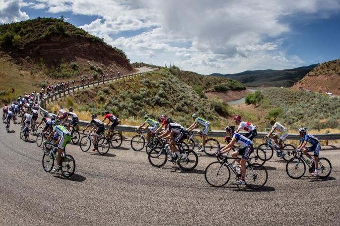 The peloton stays strung out as breaks go up the road.