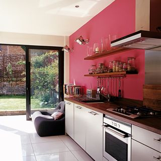 kitchen with glass sliding doors pink wall and porcelain floor tiles