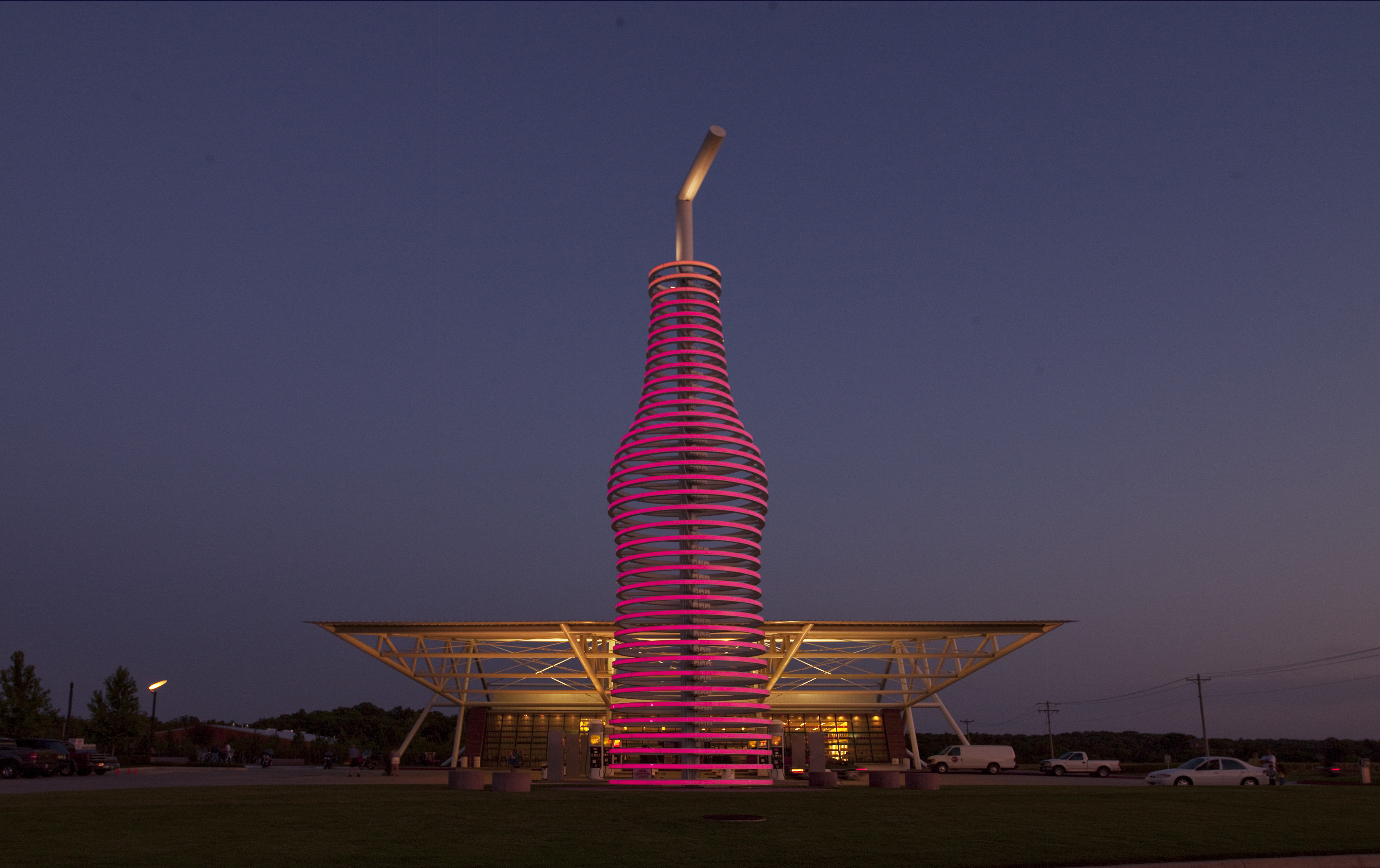 The illuminated soda bottle in front of Pops 66 at dusk