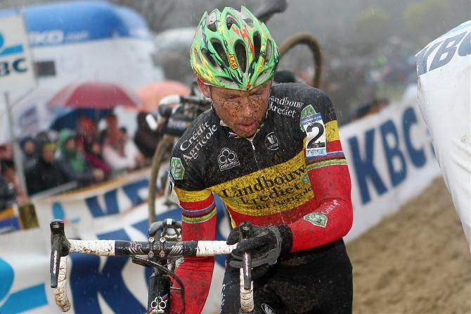 Belgian champion Sven Nys reaches down to shoulder his bike.