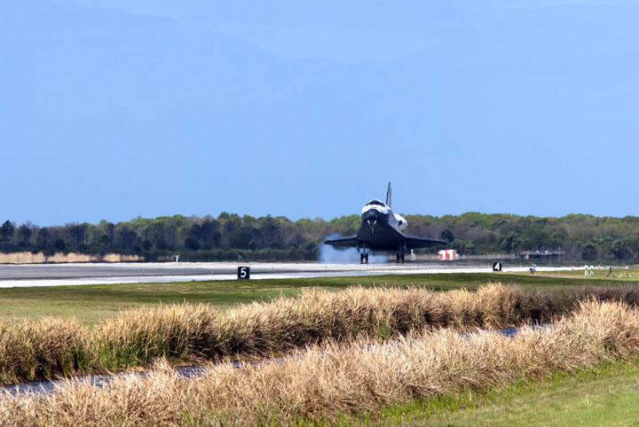 Space shuttle Discovery touches down on Runway 15 at the Shuttle Landing Facility at NASA&#039;s Kennedy Space Center in Florida. Landing was at 11:57 a.m. EST