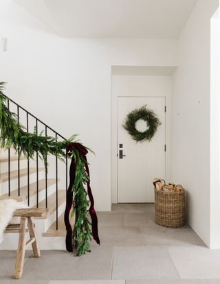 Christmas entryway with staircase garland by Marie Flanigan Interiors