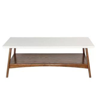 A coffee table with a white top and dark brown legs and shelf beneath it