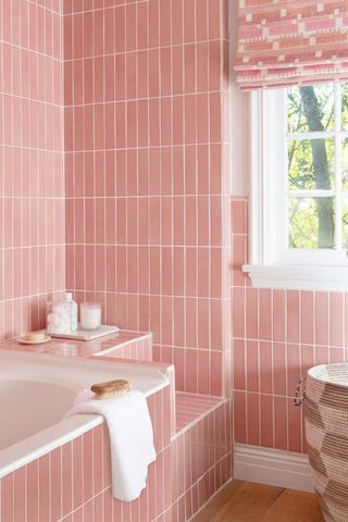 bathroom with pink subway tiles laid vertically