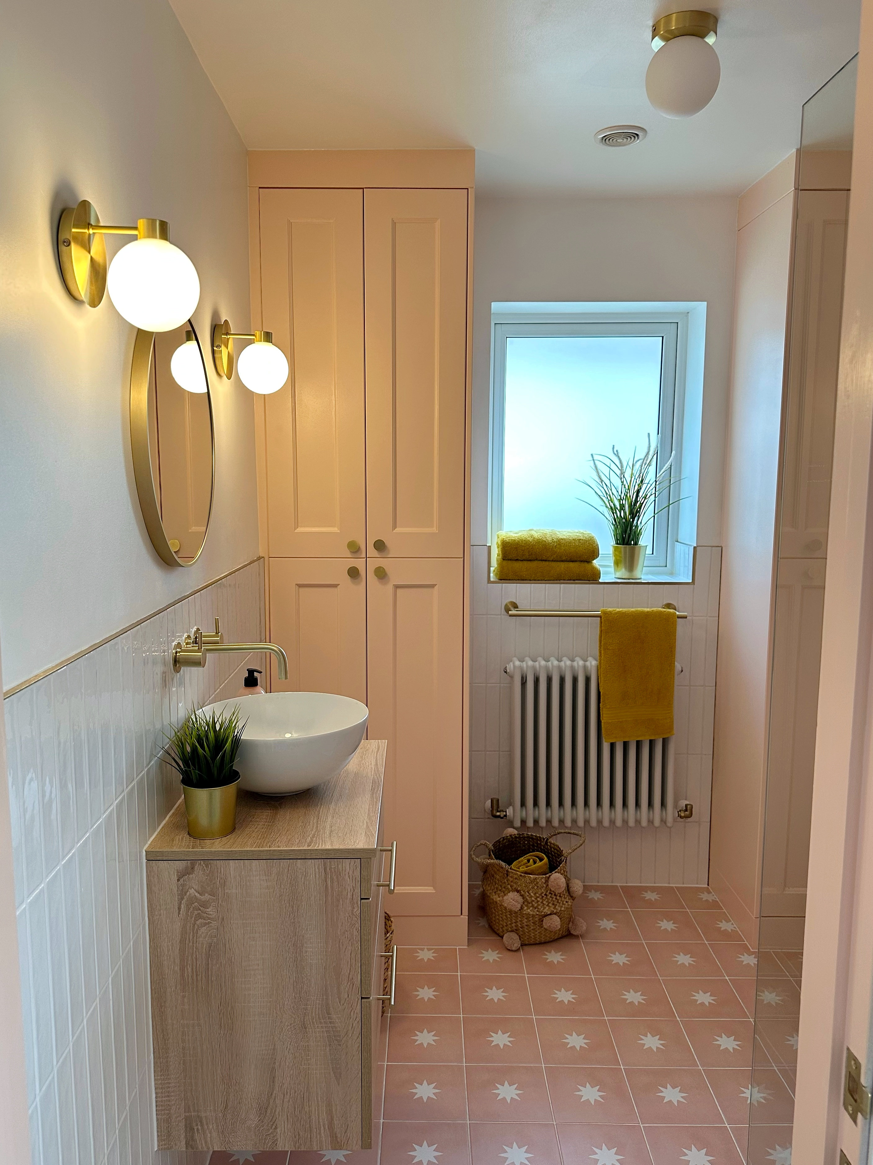 A newly-renovated bathroom with pink walls