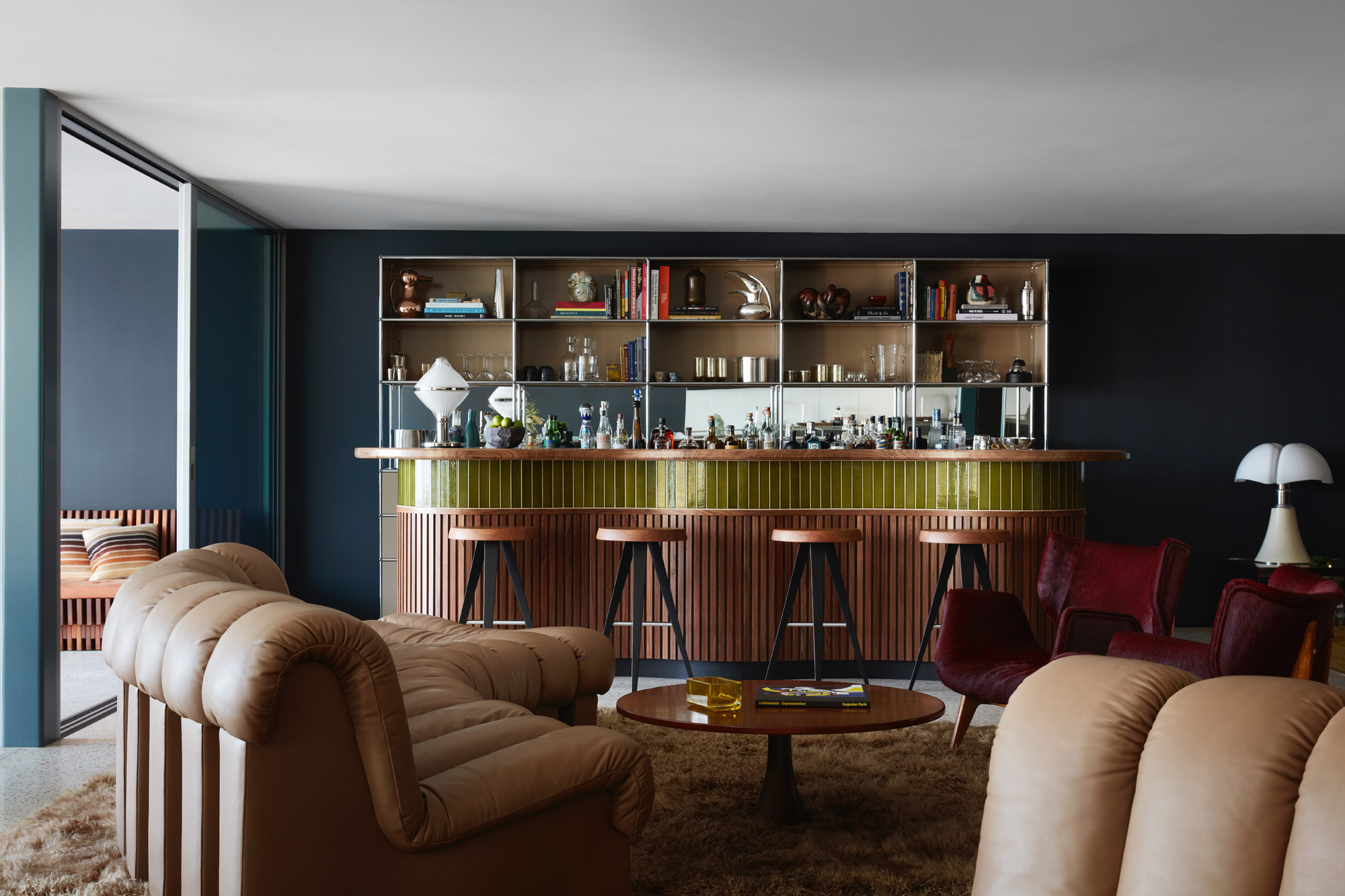 golden bar against blue wall at Malibu beach house by Studio Shamshiri