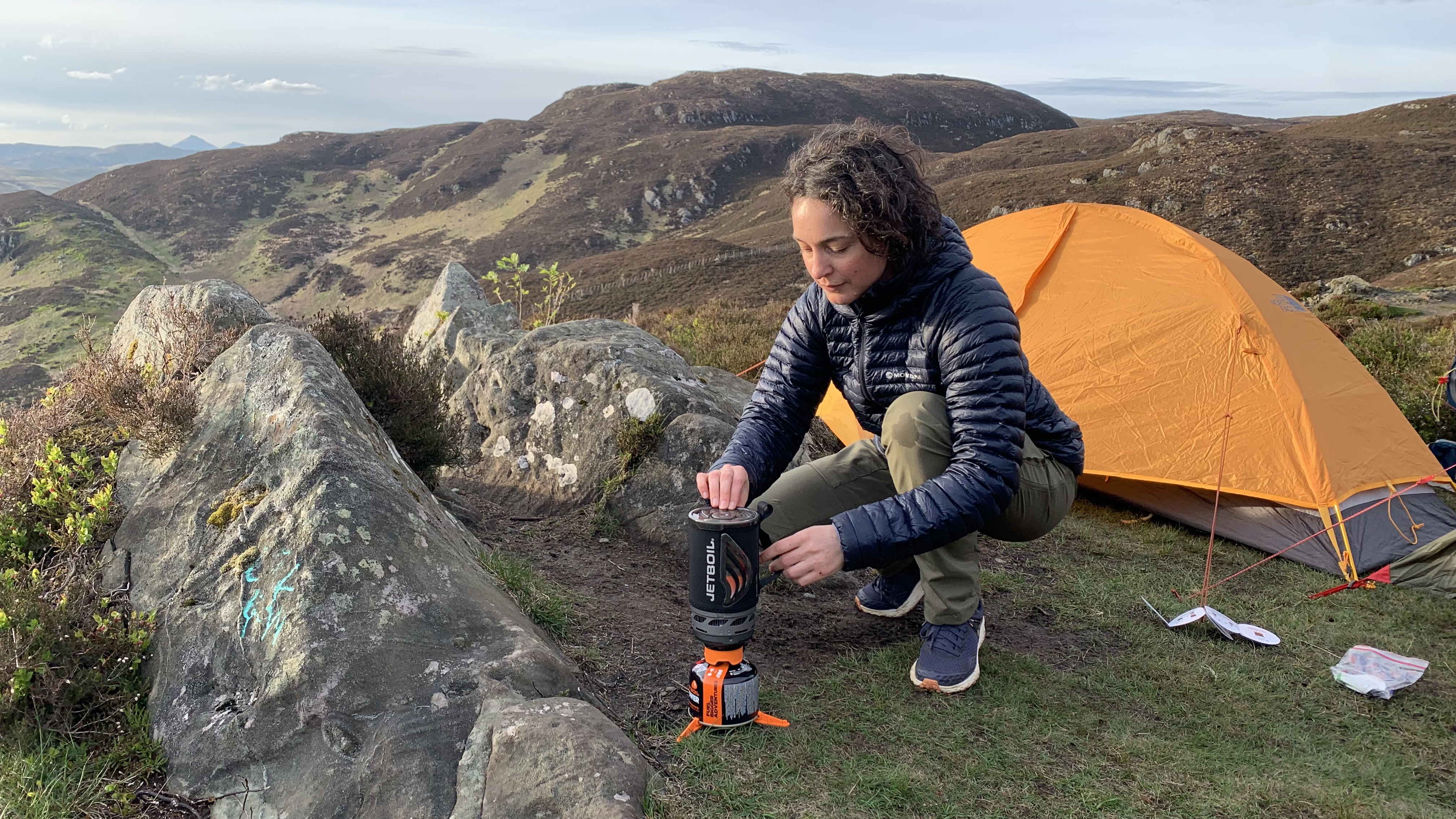 Julia Clarke cooking with the Jetboil Flash 1.0 next to a yellow tent