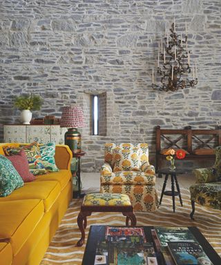 living area of historical property with yellow sofa and patterned armchair