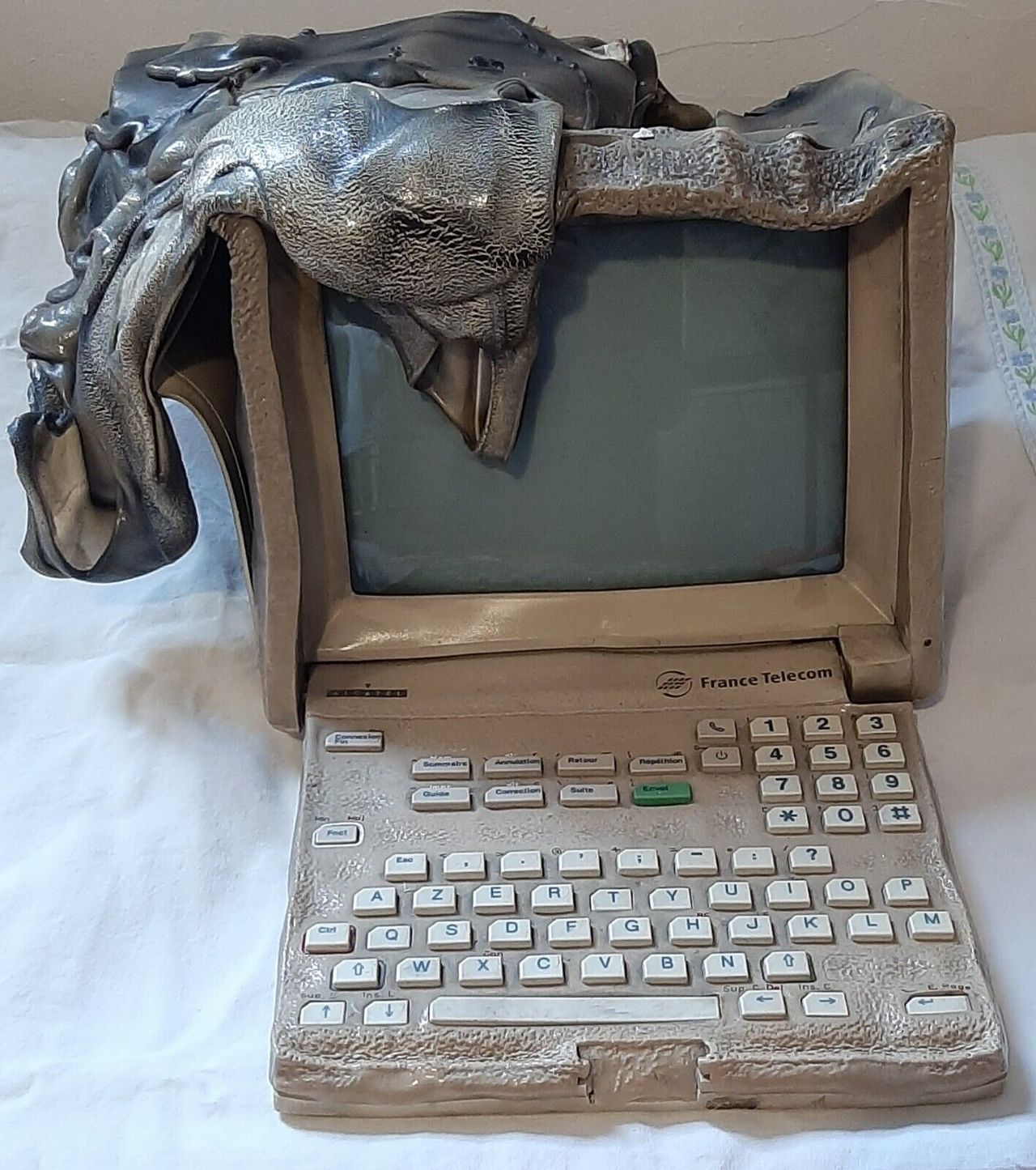 Front view of melted Alcatel initel 2