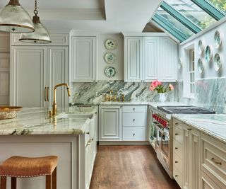 kitchen with sloping roof lights, range cooker, cream cabinets and marble topped island