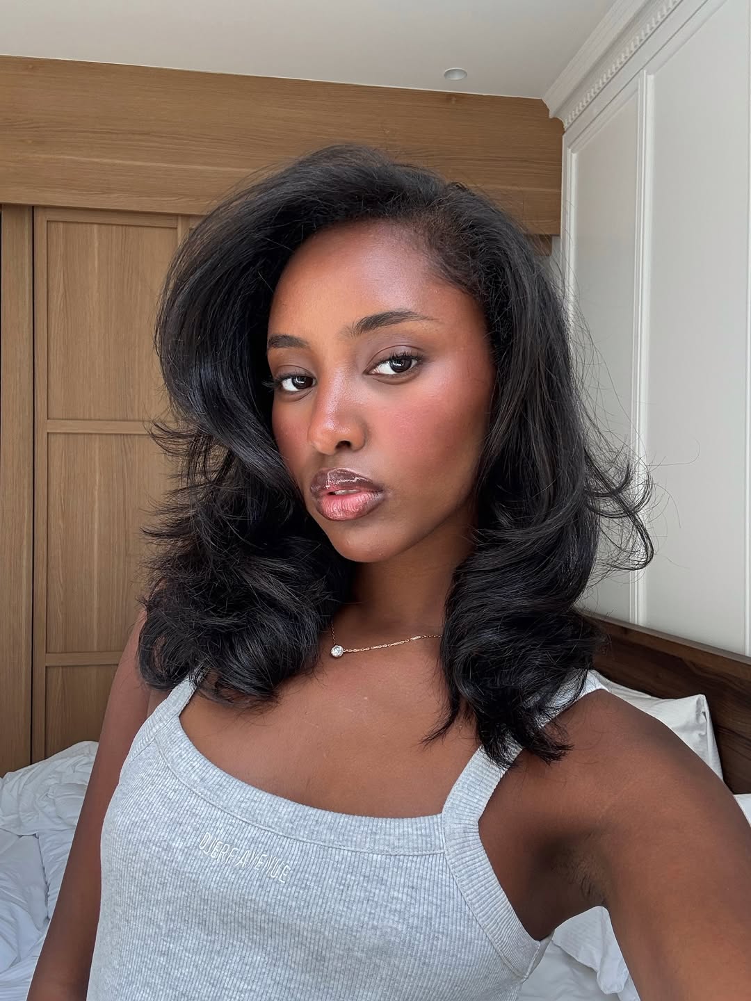 Rayan Xasan poses with glowy skin and glossy lips