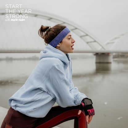 A woman doing a cold weather workout in headband and hoodie