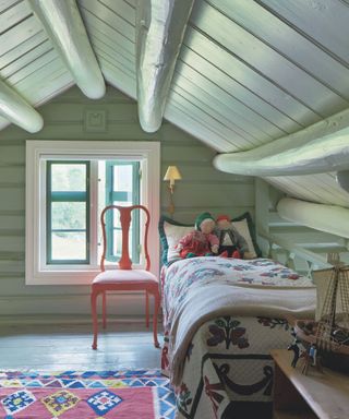 kids bedroom with sloped ceiling and beams all painted in a glossy soft sage