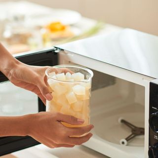 Woman melting soap base in microwave alamy 2JK188K