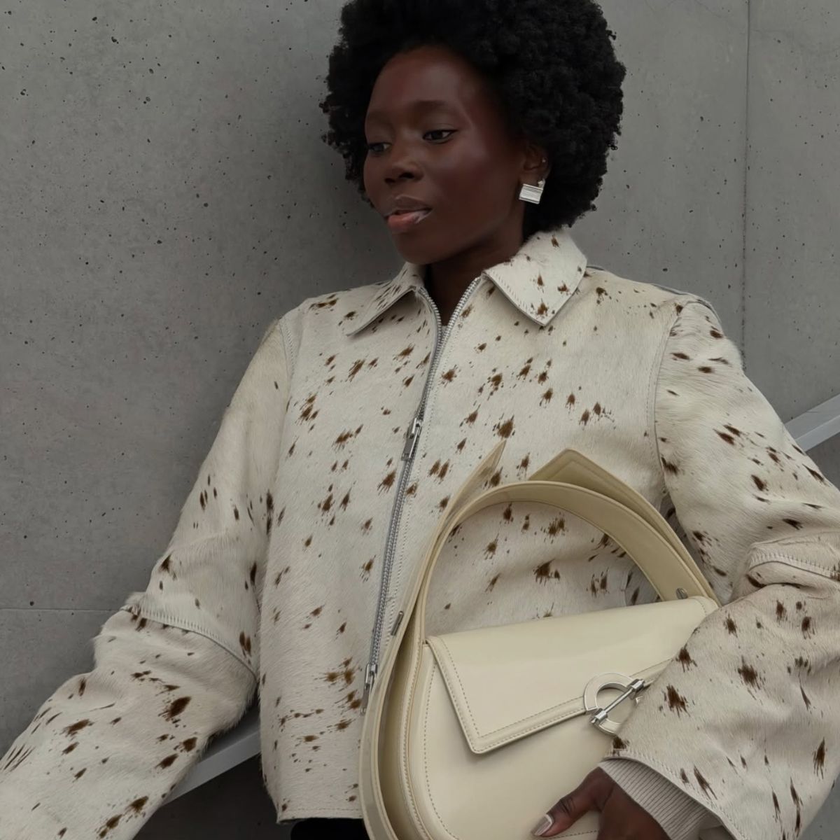 Danielle Jinadu with animal print jacket and cream bag 