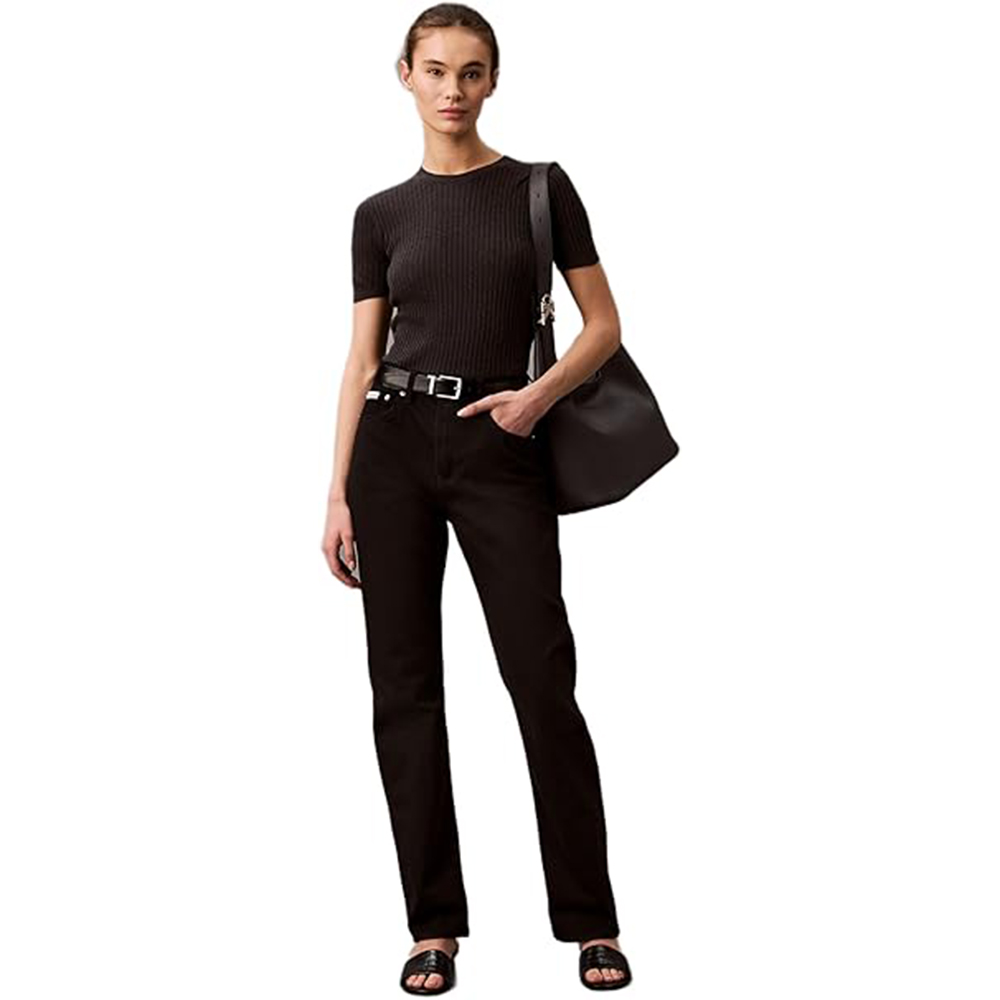 Calvin Klein model wearing black shirt and black jeans