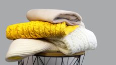 Jumpers folded on a table as the best way to store jumpers -1290463318
