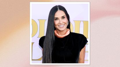 Image of Demi Moore smiling with long straight black hair and wearing a black dress, on a pink background