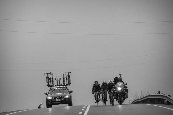 Three riders chase the front group.