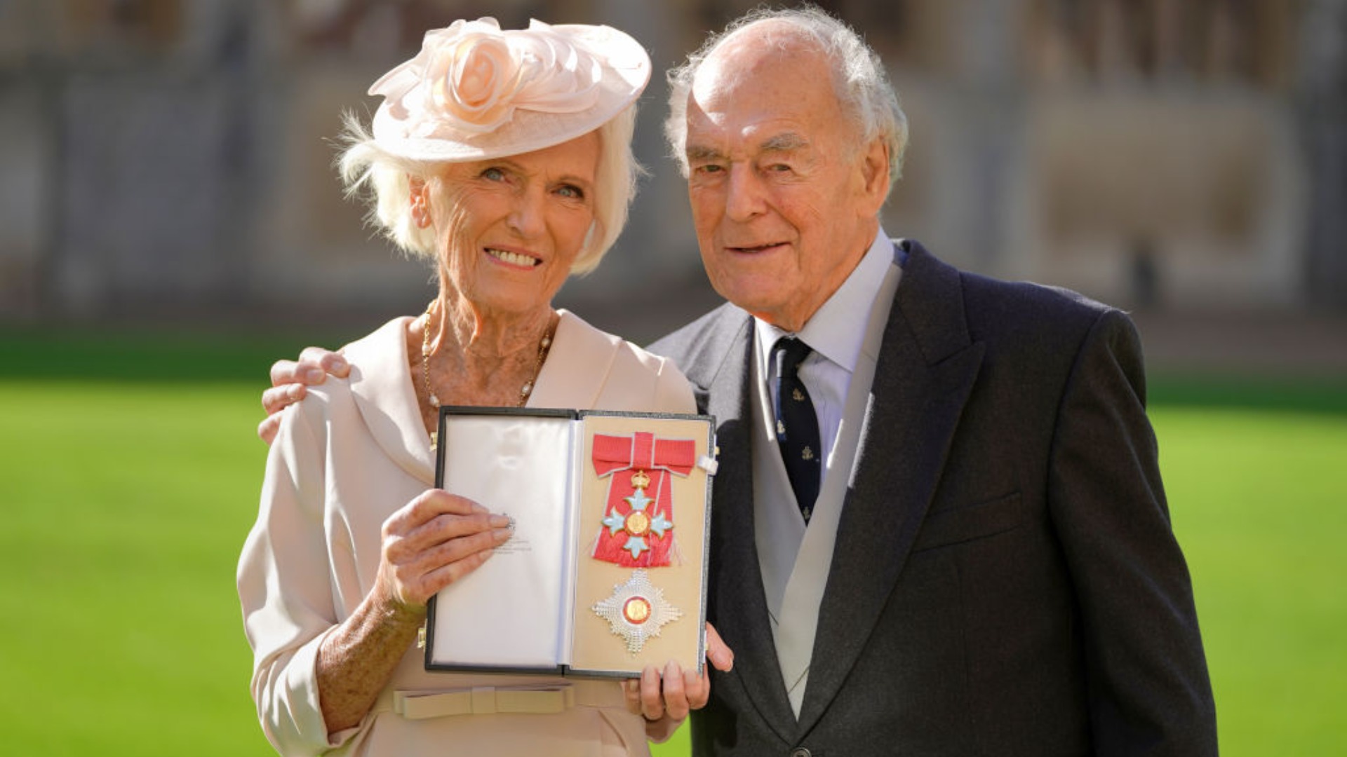Mary Berry with her husband Paul Hunnings poses with her medal and star following being appointed Dame Commander of the Order of the British Empire (DBE)